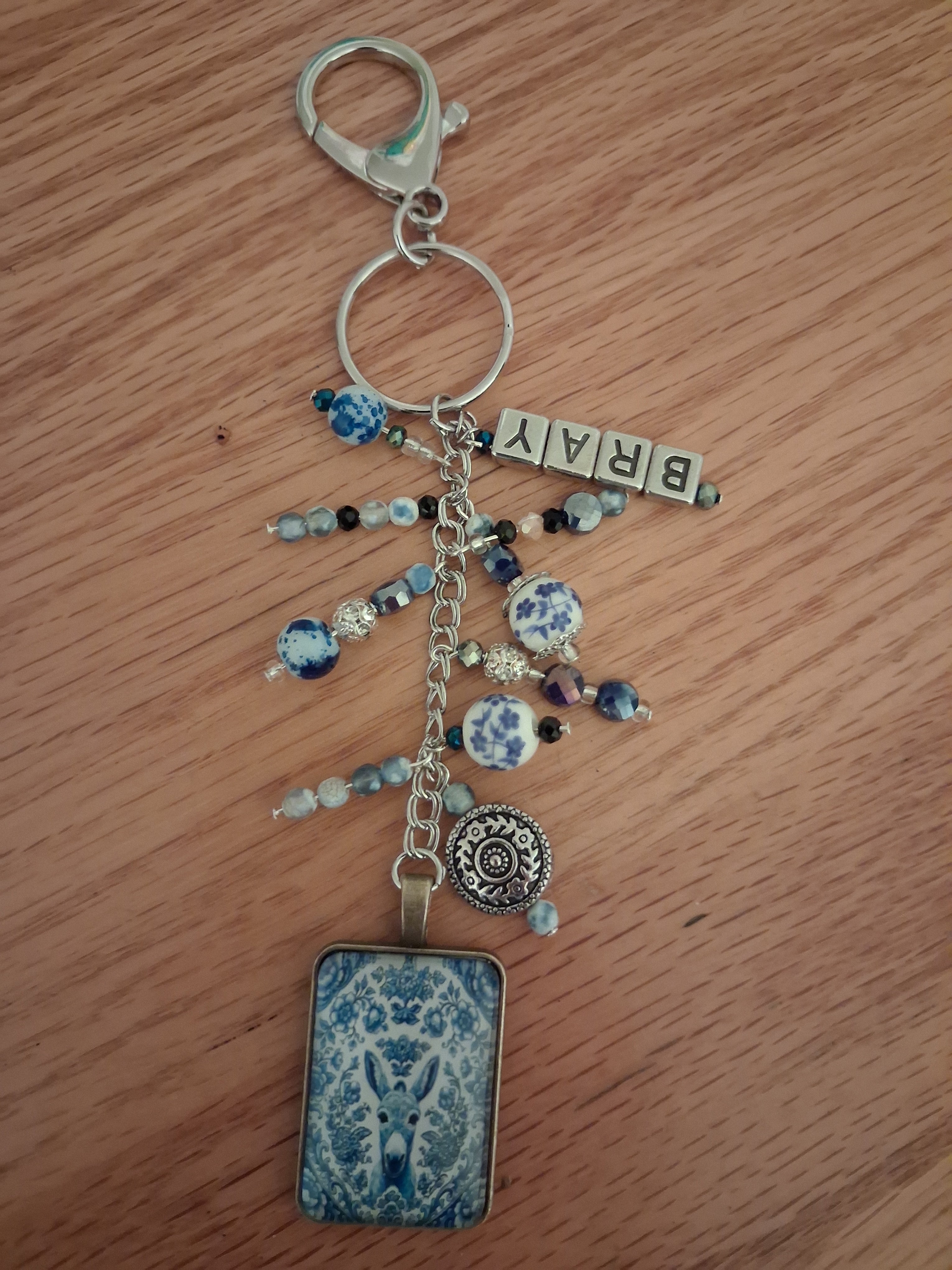 Handmade Delft donkey keychain flat lay on wood surface