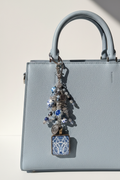 Delft Donkey Dangle Hanging Naturally on Cream Purse
