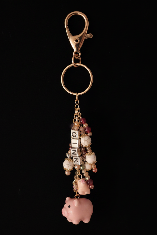 Piggy purse dangle full item on black background